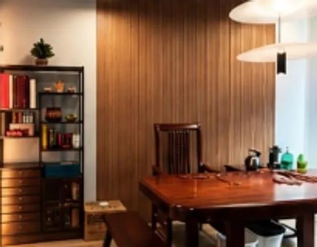 Small private room with a hardwood table, wooden wall panelling and a bookshelf